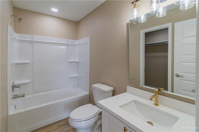 full bathroom with vanity, toilet, shower / bathing tub combination, and hardwood / wood-style flooring