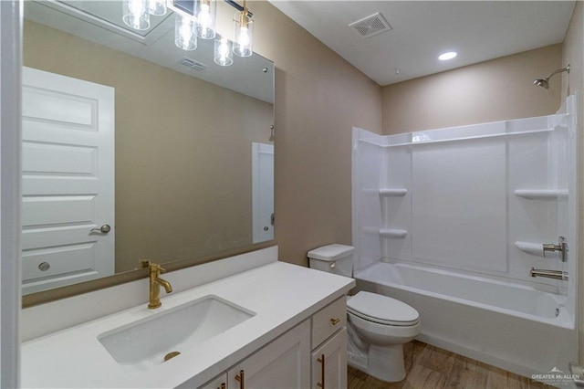 full bathroom featuring vanity, wood-type flooring,  shower combination, and toilet