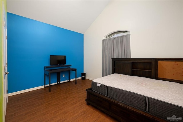 bedroom featuring hardwood / wood-style floors and vaulted ceiling