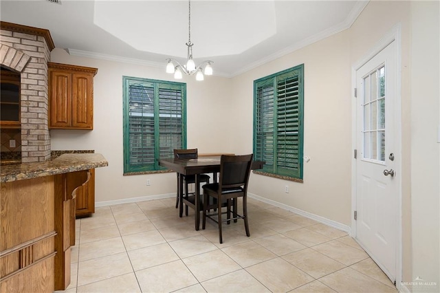 tiled dining space featuring ornamental molding and a notable chandelier