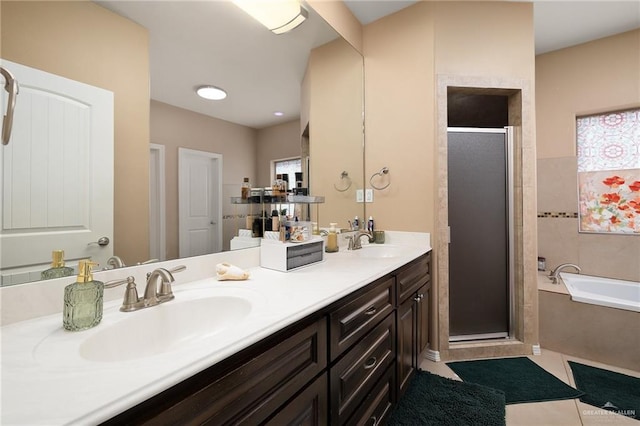 bathroom featuring tile patterned flooring, plus walk in shower, and vanity