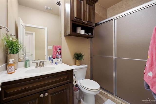 bathroom with walk in shower, vanity, toilet, and tile patterned flooring