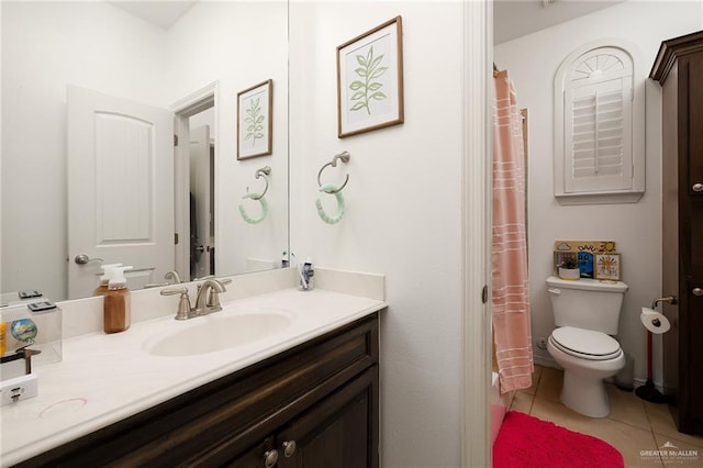 bathroom with tile patterned flooring, vanity, and toilet