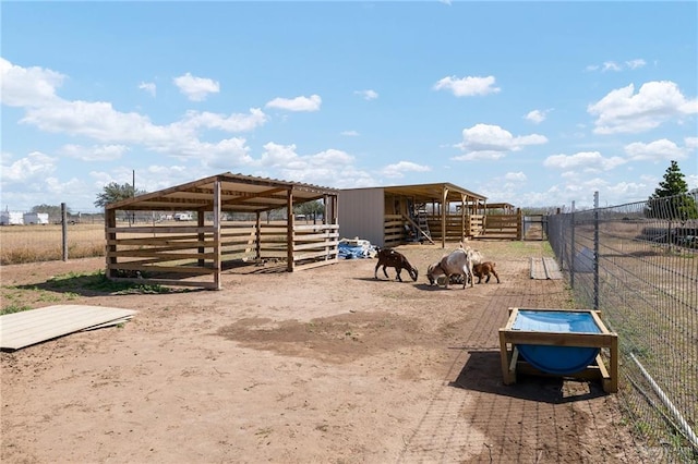 view of horse barn featuring a rural view