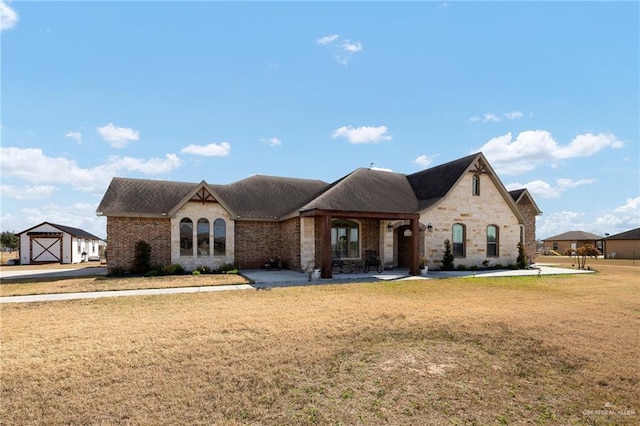 view of front of property with a shed and a front yard