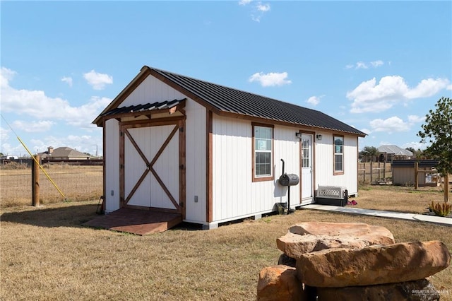 view of outbuilding with a yard