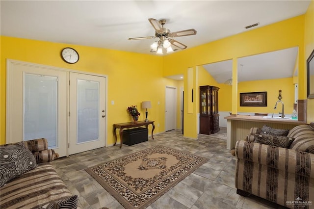 living room featuring ceiling fan and sink