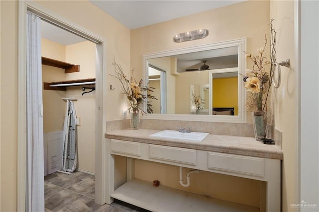 bathroom with ceiling fan and vanity