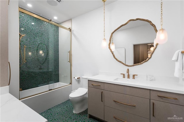 5705 Laguna Cir S, South Padre Island, TX 78597 - bathroom featuring vanity, enclosed tub / shower combo, recessed lighting, and toilet