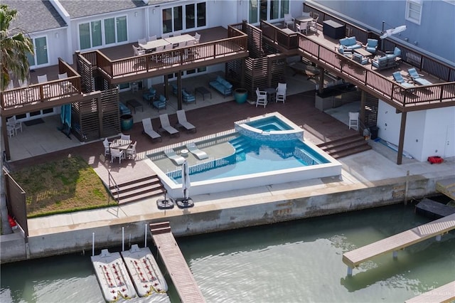 5705 Laguna Cir S, South Padre Island, TX 78597 - exterior space with a deck with water view, stairs, a pool with connected hot tub, and a patio