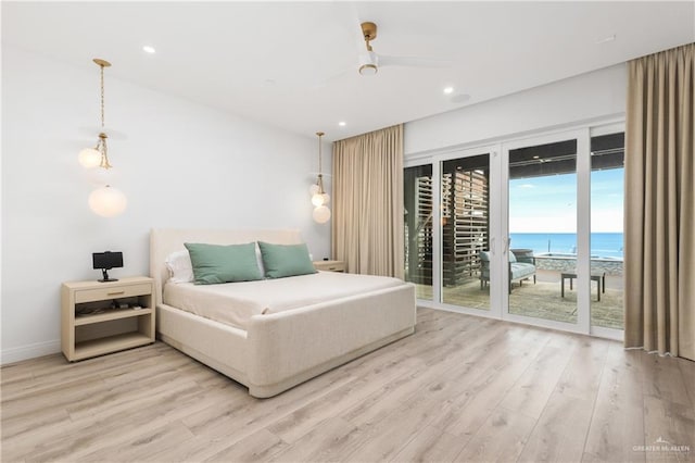 5705 Laguna Cir S, South Padre Island, TX 78597 - bedroom with a water view, access to exterior, light wood finished floors, and recessed lighting
