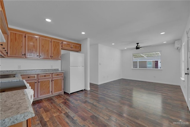 kitchen with a wall mounted AC, ceiling fan, dark hardwood / wood-style floors, and white appliances