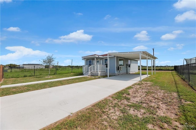 view of front of house with a front lawn and a carport