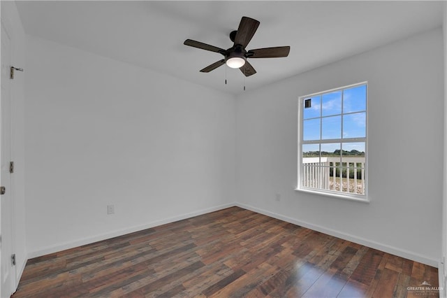 spare room featuring ceiling fan and dark hardwood / wood-style floors