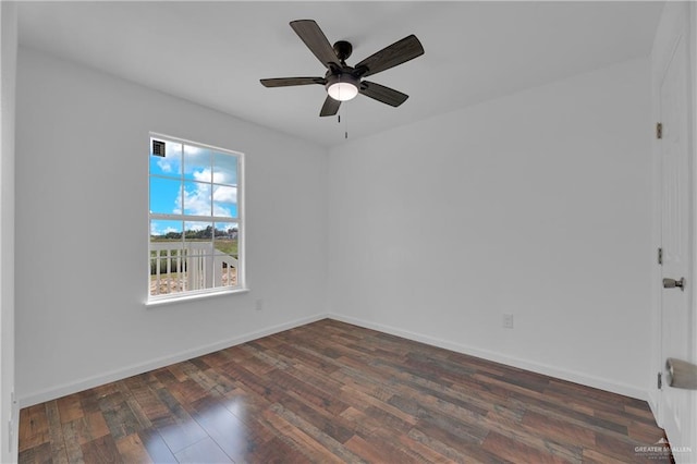 empty room with ceiling fan and dark hardwood / wood-style flooring