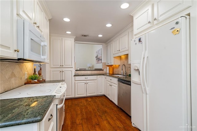 kitchen featuring white appliances, visible vents, a sink, and white cabinetry