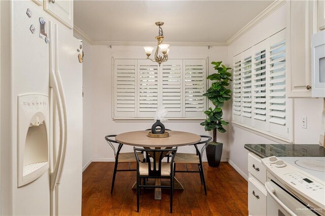 dining area with baseboards, an inviting chandelier, dark wood finished floors, and crown molding