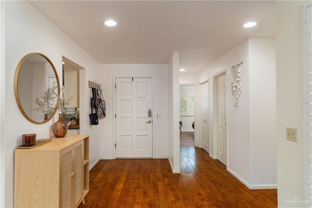 corridor featuring recessed lighting, dark wood finished floors, and baseboards