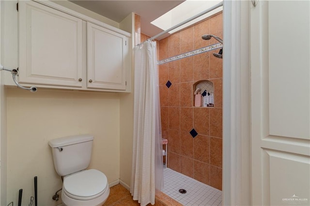 bathroom featuring a shower stall and toilet