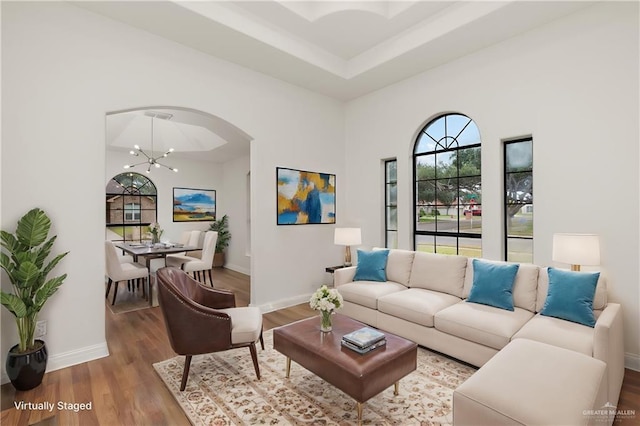 living room featuring hardwood / wood-style flooring and an inviting chandelier