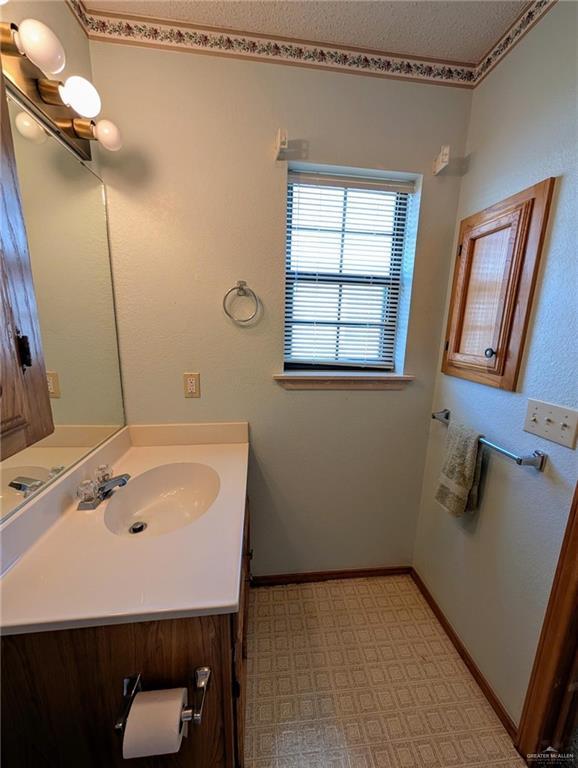 109 Green Gate Cir N, Palmview, TX 78572 - bathroom featuring vanity, tile patterned floors, and a textured ceiling
