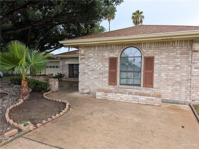 109 Green Gate Cir N, Palmview, TX 78572 - view of home's exterior featuring roof with shingles and brick siding
