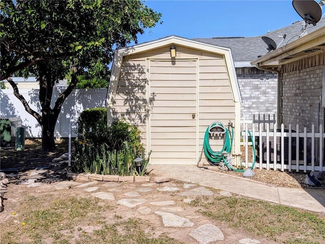 109 Green Gate Cir N, Palmview, TX 78572 - view of home's exterior featuring a storage unit, a fenced backyard, and roof with shingles