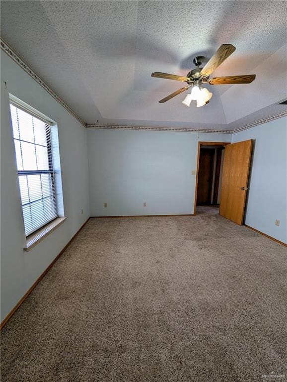 109 Green Gate Cir N, Palmview, TX 78572 - empty room featuring ceiling fan, light colored carpet, a textured ceiling, and a raised ceiling