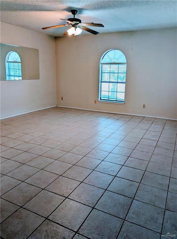 109 Green Gate Cir N, Palmview, TX 78572 - unfurnished room featuring a textured ceiling, a ceiling fan, and light tile patterned floors