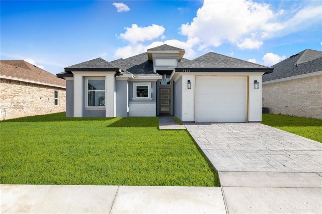 prairie-style home with a garage and a front yard