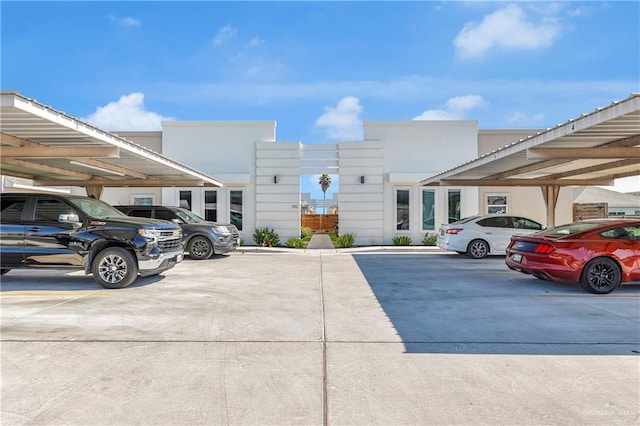 view of parking / parking lot featuring a carport