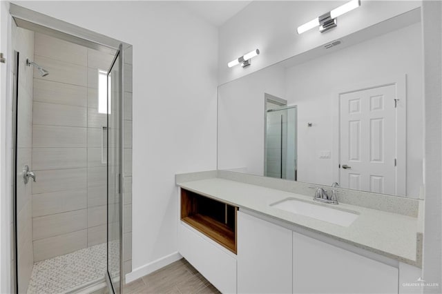 bathroom featuring vanity and a shower with shower door