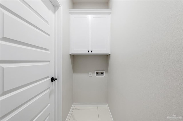 laundry area featuring tile patterned flooring, cabinets, and hookup for a washing machine