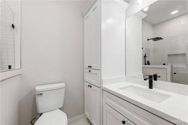 bathroom featuring vanity, toilet, and walk in shower