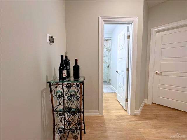 hallway with light hardwood / wood-style floors