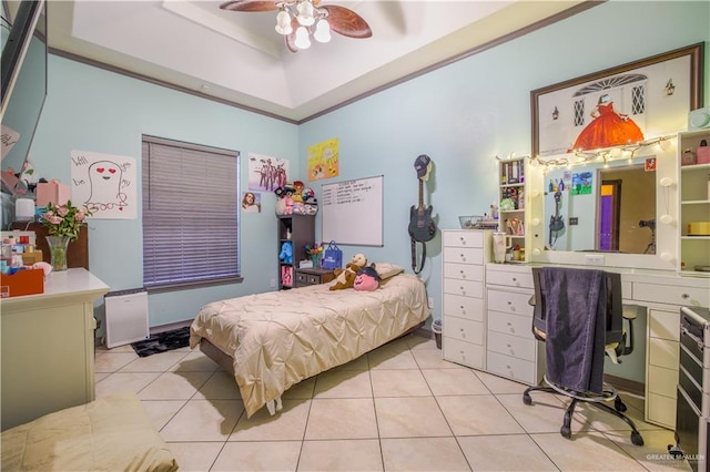 bedroom featuring a raised ceiling, ceiling fan, and light tile patterned flooring