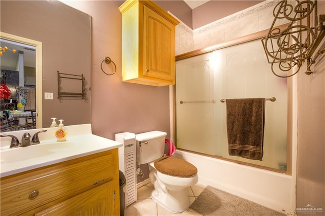 full bathroom with toilet, vanity, tile patterned floors, and enclosed tub / shower combo