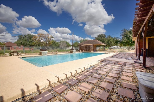 view of swimming pool featuring pool water feature and a patio area