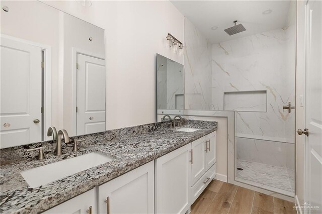 820 N Brushfield Ave, Edinburg, TX 78541 - full bathroom with a marble finish shower, double vanity, and wood finished floors