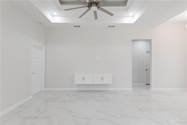 2208 Zinnia St, Weslaco, TX 78599 - spare room featuring a tray ceiling, ceiling fan, baseboards, recessed lighting, and light marble finish floors