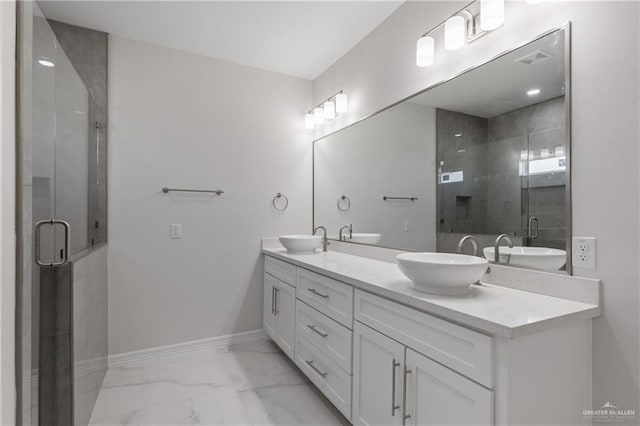 2208 Zinnia St, Weslaco, TX 78599 - bathroom with marble finish floors, double vanity, a shower stall, and baseboards