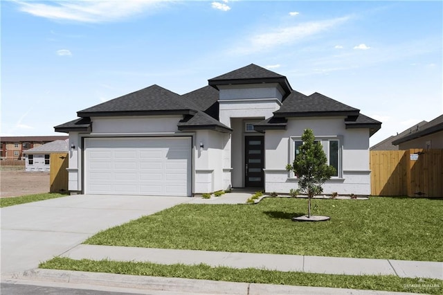 2208 Zinnia St, Weslaco, TX 78599 - prairie-style house featuring stucco siding, an attached garage, concrete driveway, and a shingled roof