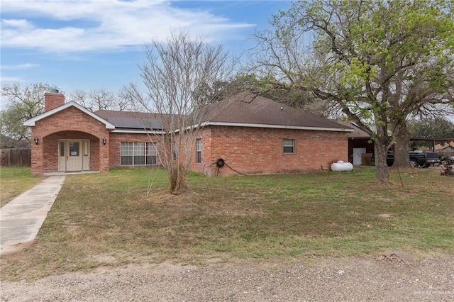 view of property exterior with a yard and solar panels