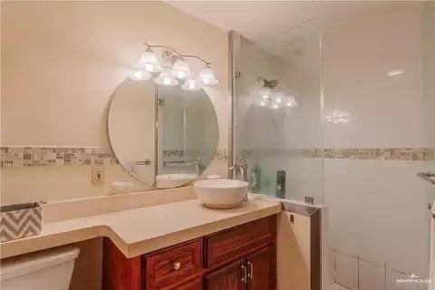 bathroom with tile walls, toilet, and vanity