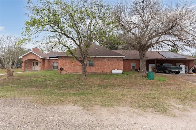 view of front facade with a front yard and a carport