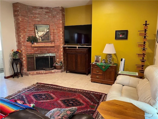 living room with a brick fireplace and light tile patterned flooring