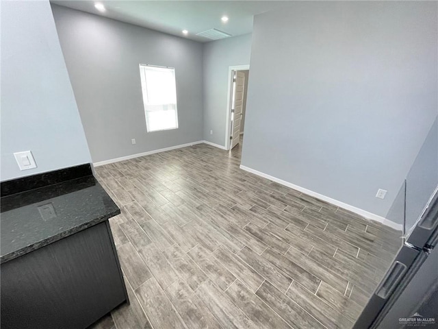 interior space with recessed lighting, visible vents, baseboards, and wood finished floors