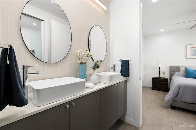 bathroom with tile patterned floors, vanity, and ceiling fan