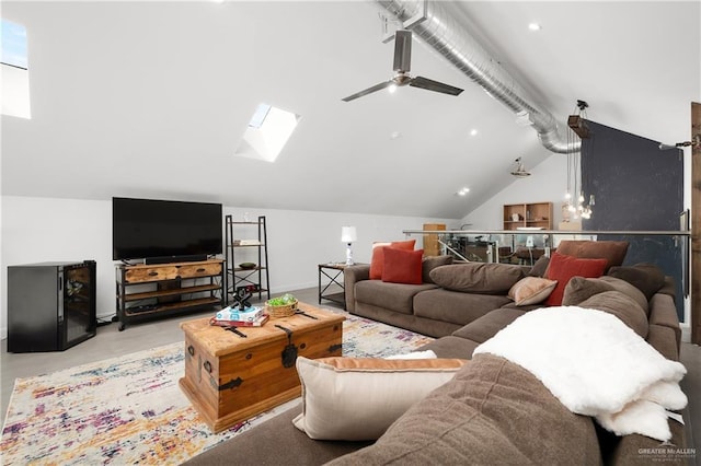 living room featuring lofted ceiling with skylight and ceiling fan