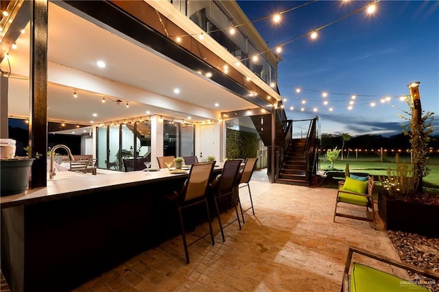 patio terrace at dusk with an outdoor bar